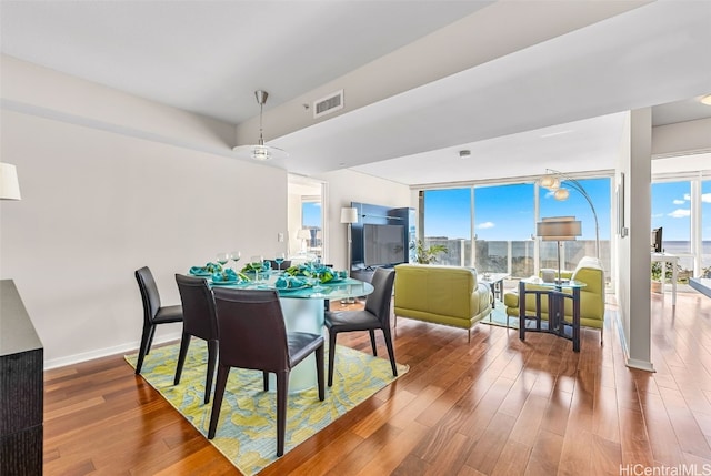 dining space with hardwood / wood-style flooring and expansive windows