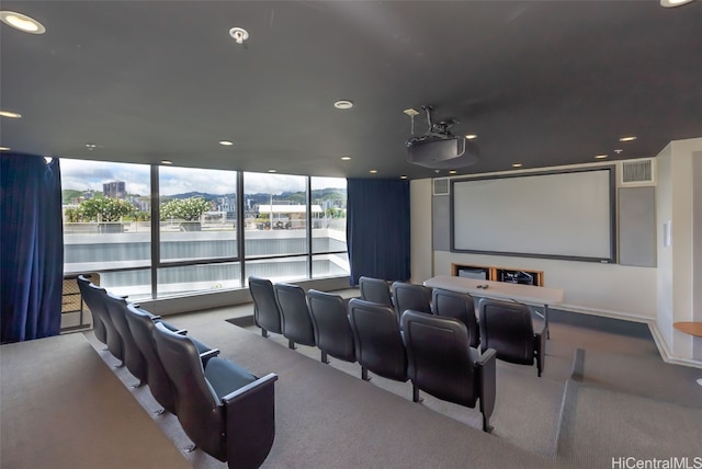 home theater room featuring light colored carpet