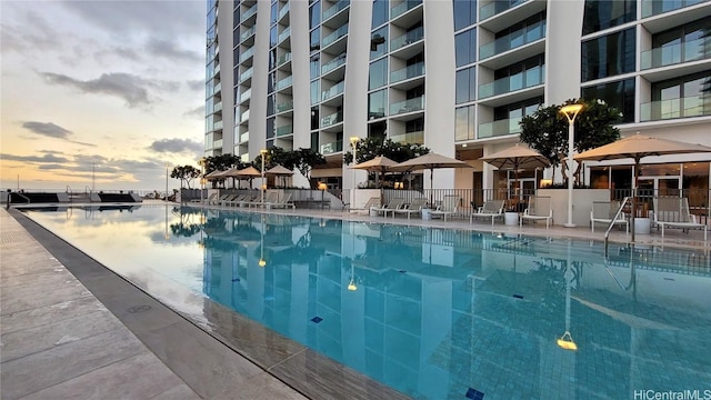 view of pool at dusk