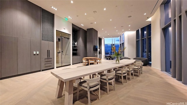 kitchen featuring a wall of windows, a large island, and a breakfast bar area