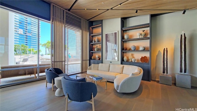 living area featuring hardwood / wood-style floors, built in features, and wooden ceiling