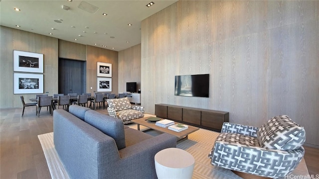 living room with a towering ceiling and hardwood / wood-style floors