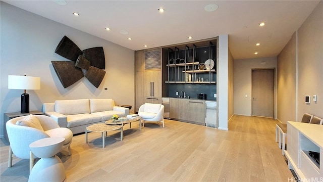 living room with wet bar and light hardwood / wood-style floors