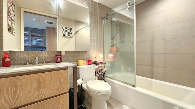 full bathroom featuring tiled shower / bath combo, vanity, backsplash, and toilet