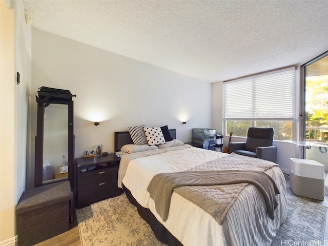 bedroom featuring hardwood / wood-style floors and a textured ceiling