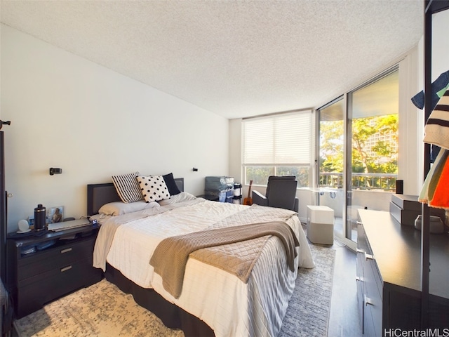 bedroom featuring hardwood / wood-style flooring and a textured ceiling