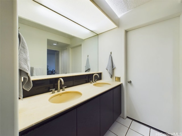 bathroom featuring tile patterned floors, a textured ceiling, and vanity