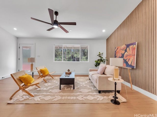 living room with light hardwood / wood-style flooring and ceiling fan