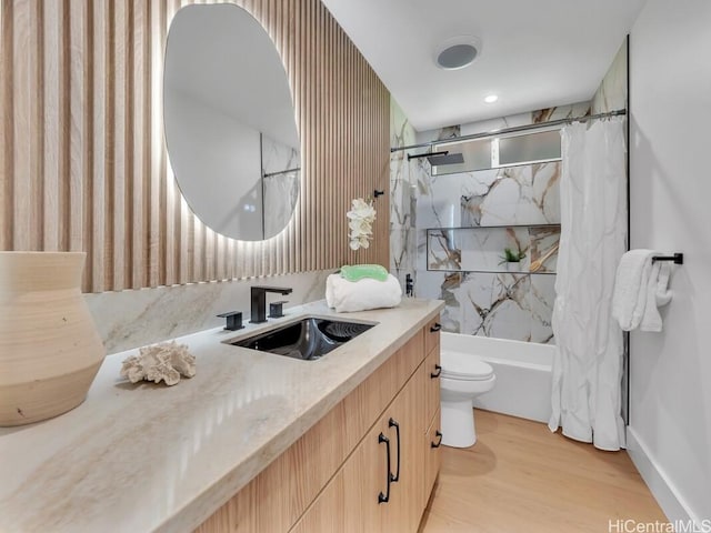 full bathroom featuring vanity, hardwood / wood-style floors, shower / bathtub combination with curtain, and toilet