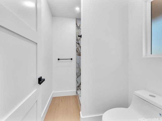 bathroom featuring hardwood / wood-style floors and toilet