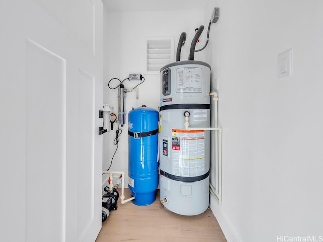 utility room featuring secured water heater