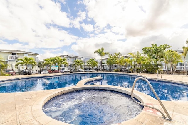 view of swimming pool featuring a community hot tub