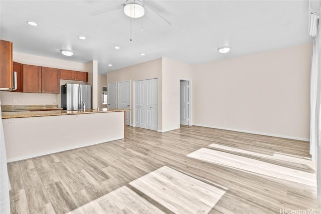 kitchen featuring ceiling fan, stainless steel fridge, and light hardwood / wood-style floors