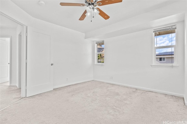 carpeted empty room featuring ceiling fan