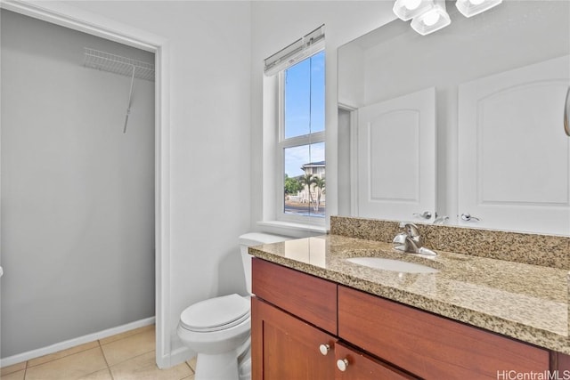 bathroom featuring vanity, tile patterned floors, and toilet