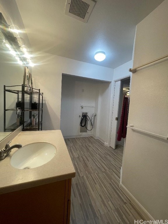 bathroom featuring hardwood / wood-style flooring and vanity