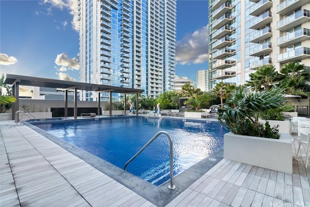 pool with a patio area and a city view