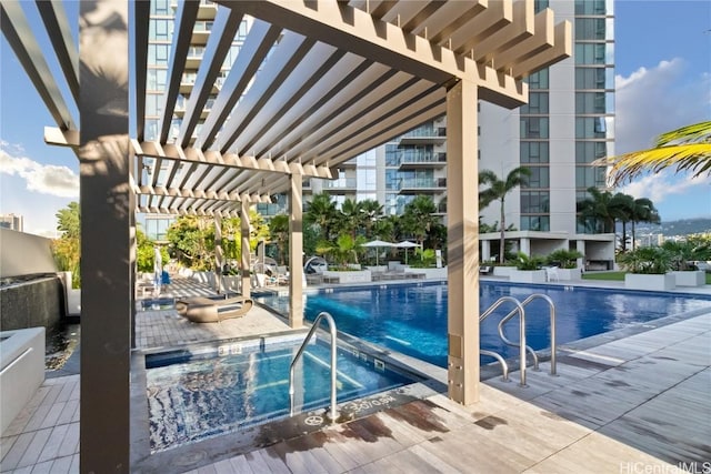 pool featuring a patio area, a community hot tub, and a pergola