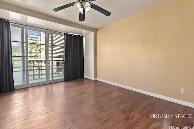 spare room with hardwood / wood-style flooring and ceiling fan