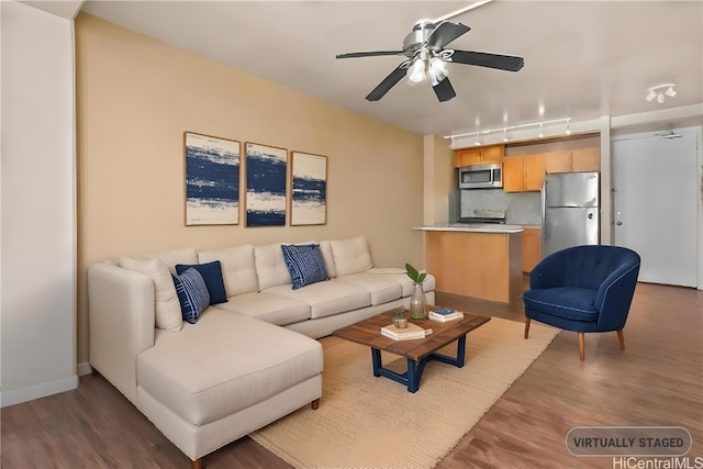 living room featuring ceiling fan, dark hardwood / wood-style flooring, and rail lighting