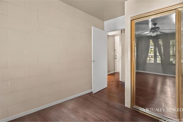 interior space featuring dark wood-type flooring and ceiling fan