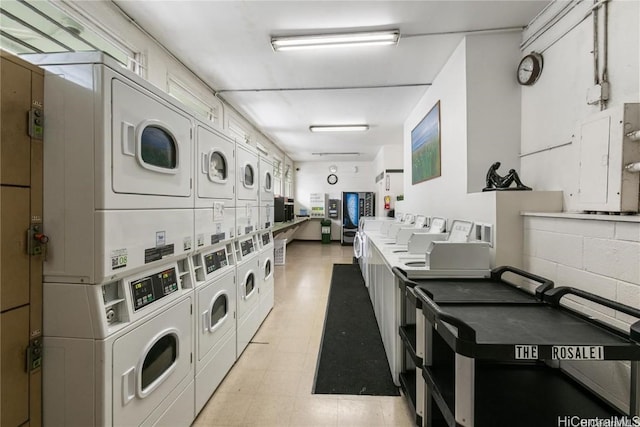 washroom with stacked washer / dryer, electric panel, and independent washer and dryer