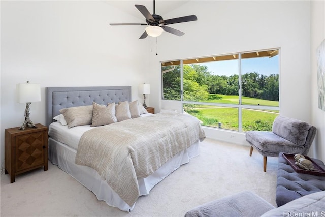 bedroom featuring ceiling fan, high vaulted ceiling, and light colored carpet