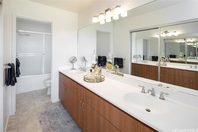 bathroom featuring a sink, toilet, and tile patterned floors