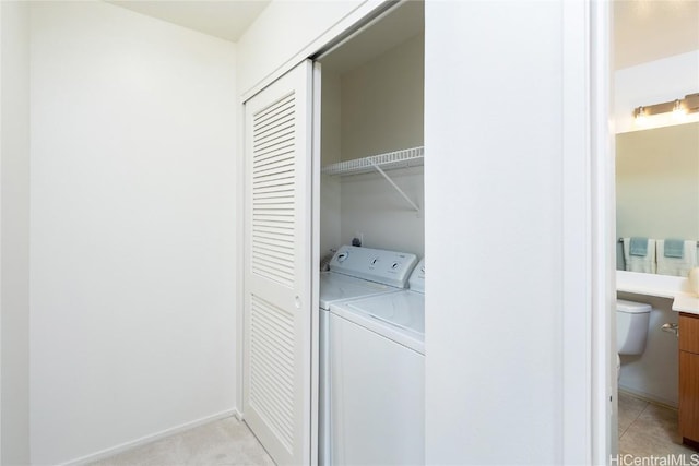 laundry area featuring laundry area, baseboards, and separate washer and dryer