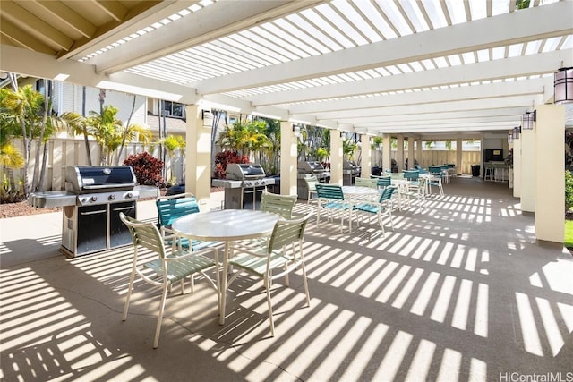 view of patio / terrace featuring fence, grilling area, a pergola, and outdoor dining space