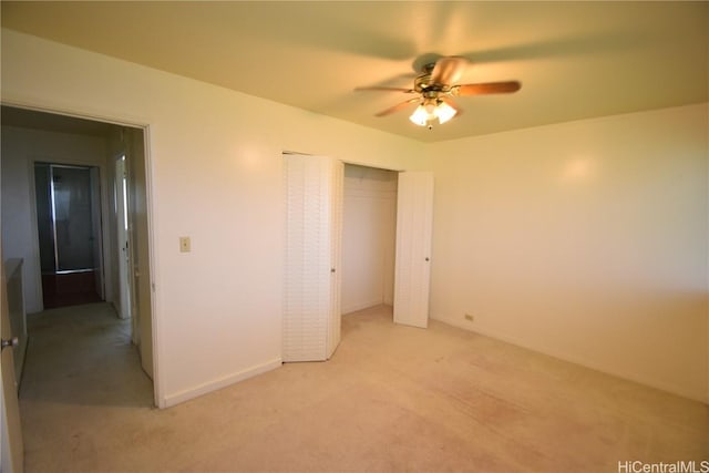 unfurnished bedroom featuring light colored carpet, ceiling fan, and a closet