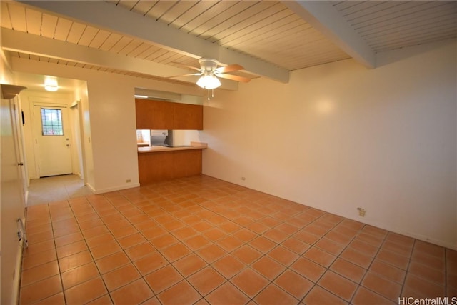 unfurnished living room featuring ceiling fan, beam ceiling, and light tile patterned floors