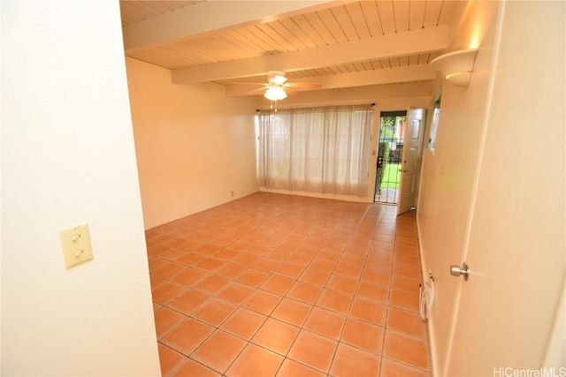 tiled empty room featuring beam ceiling and ceiling fan