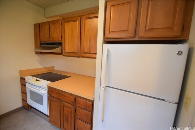 kitchen with white appliances and light tile patterned flooring