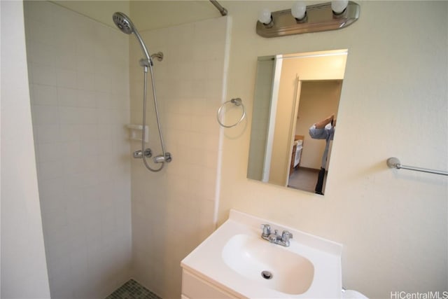 bathroom featuring vanity and tiled shower