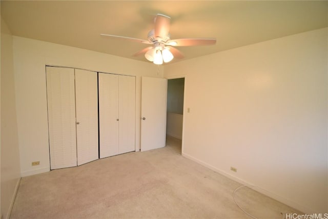 unfurnished bedroom with light colored carpet, ceiling fan, and a closet