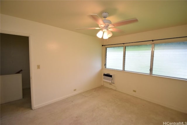 carpeted empty room featuring ceiling fan and a wall mounted air conditioner