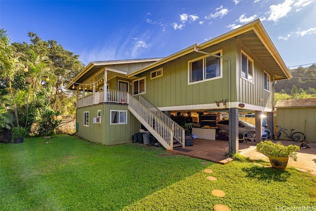 rear view of property featuring a yard and a patio