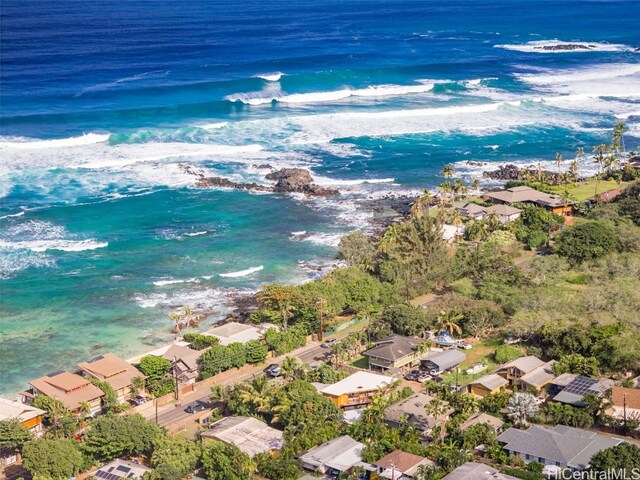 drone / aerial view with a water view and a beach view