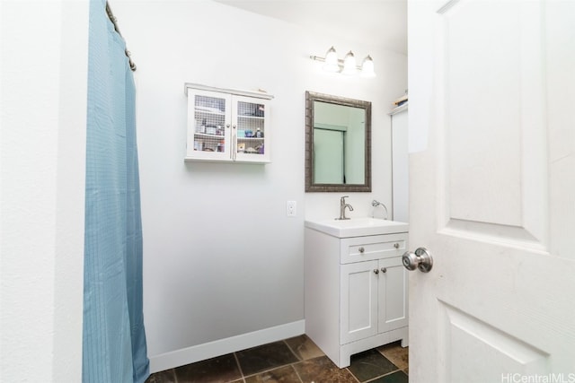 bathroom with walk in shower, tile patterned floors, and vanity