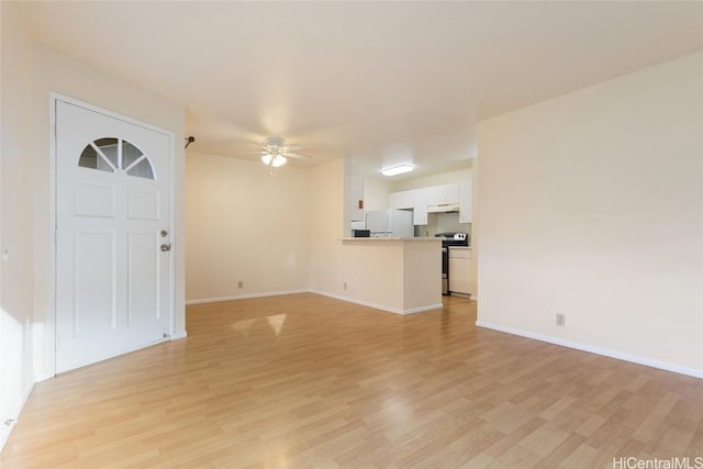 unfurnished living room with ceiling fan and light hardwood / wood-style floors