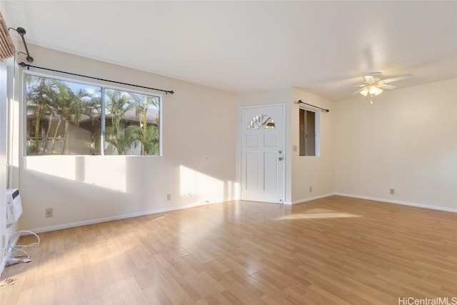 unfurnished living room featuring ceiling fan and light wood-type flooring