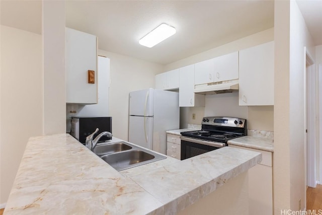 kitchen featuring white cabinetry, sink, stainless steel range with electric stovetop, white refrigerator, and light wood-type flooring