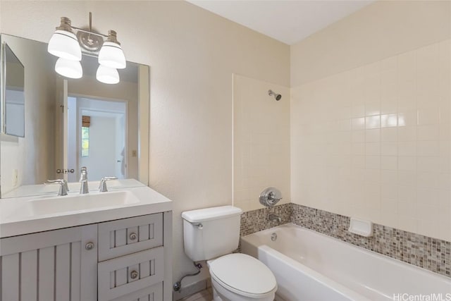 full bathroom with vanity, tiled shower / bath, and toilet