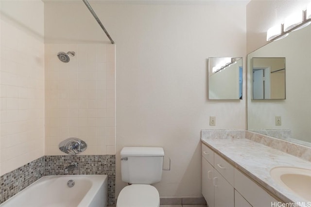 full bathroom with tiled shower / bath, vanity, and toilet