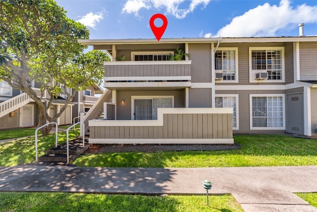 back of property featuring cooling unit, a lawn, and a balcony