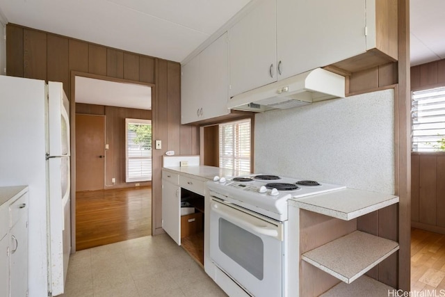 kitchen featuring white appliances and white cabinets