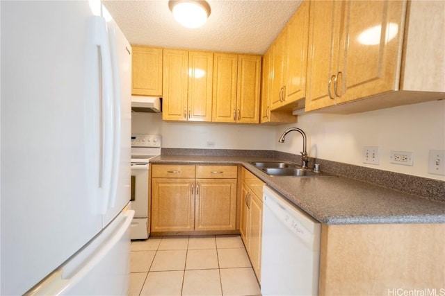 kitchen with sink, light tile patterned floors, a textured ceiling, and white appliances