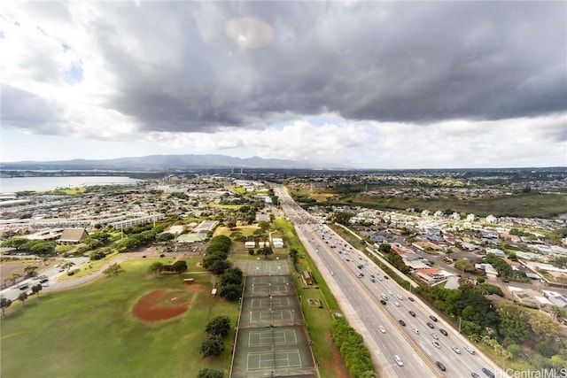 birds eye view of property with a water and mountain view