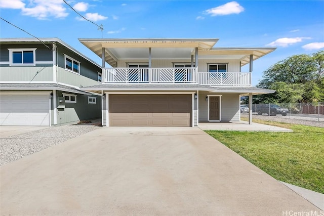 view of front of home with a balcony, a garage, and a front lawn